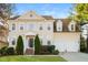 Charming two-story home featuring a well-maintained lawn, mature landscaping, and an attached two-car garage at 165 Sutherland Dr, Franklinton, NC 27525