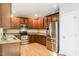 Spacious kitchen features stainless steel appliances, wooden cabinetry, and granite countertops at 165 Sutherland Dr, Franklinton, NC 27525