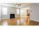 Bright living room with hardwood floors, a fireplace, and large windows offering plenty of natural light at 165 Sutherland Dr, Franklinton, NC 27525