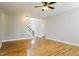 Open living area with hardwood floors, a ceiling fan, and stairs to the second floor at 165 Sutherland Dr, Franklinton, NC 27525