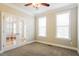 Home office space with large windows, plush carpet, and glass panel french doors at 165 Sutherland Dr, Franklinton, NC 27525