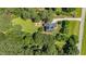 Aerial view of a home featuring solar panels, backyard playground, and lush greenery at 1809 Bowling Rd, Fuquay Varina, NC 27526