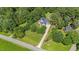 Inviting two-story home with a long driveway, mature trees, and spacious front yard at 1809 Bowling Rd, Fuquay Varina, NC 27526