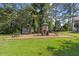 Backyard featuring a playset and wood chip ground cover at 1809 Bowling Rd, Fuquay Varina, NC 27526