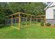 Large backyard featuring a framed garden with metal fencing and green grass at 1809 Bowling Rd, Fuquay Varina, NC 27526