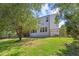 Spacious backyard featuring home exterior, well manicured green grass and garden at 1809 Bowling Rd, Fuquay Varina, NC 27526