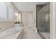 Luxury bathroom with soaking tub and walk-in shower with tile surround at 1809 Bowling Rd, Fuquay Varina, NC 27526