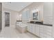 Luxury bathroom featuring double vanity, soaking tub, and separate tiled shower at 1809 Bowling Rd, Fuquay Varina, NC 27526