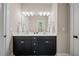 Bathroom featuring double vanity with modern fixtures and vanity mirror at 1809 Bowling Rd, Fuquay Varina, NC 27526