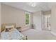 Bright bedroom featuring a window view and neutral color scheme at 1809 Bowling Rd, Fuquay Varina, NC 27526