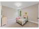 Bright bedroom with a twin bed, neutral walls, carpet, and natural light from the window at 1809 Bowling Rd, Fuquay Varina, NC 27526