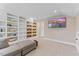 Bonus room featuring neutral walls, carpet, a sectional sofa, built-in shelving, and a TV at 1809 Bowling Rd, Fuquay Varina, NC 27526