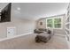 Bonus room featuring neutral walls, carpet, a sectional sofa, and built-in shelving at 1809 Bowling Rd, Fuquay Varina, NC 27526