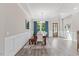 Dining room featuring hardwood floors, natural light from large windows and a modern chandelier at 1809 Bowling Rd, Fuquay Varina, NC 27526