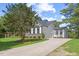 Spacious driveway leading to a well-manicured lawn, side of house, and three-car garage at 1809 Bowling Rd, Fuquay Varina, NC 27526