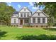 Charming two-story home featuring a well-maintained lawn, manicured landscaping, and solar panels at 1809 Bowling Rd, Fuquay Varina, NC 27526