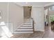 Elegant staircase in the foyer leads to the upper level, showcasing natural light at 1809 Bowling Rd, Fuquay Varina, NC 27526