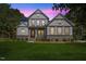 Charming two-story home showcasing a beautifully landscaped yard, stone accents, and a welcoming front porch at 1809 Bowling Rd, Fuquay Varina, NC 27526