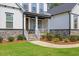 Charming front porch with swing, stone accents, and professional landscaping create a warm welcome at 1809 Bowling Rd, Fuquay Varina, NC 27526