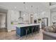 Modern kitchen featuring an island with barstool seating, stainless steel appliances, and hardwood floors at 1809 Bowling Rd, Fuquay Varina, NC 27526