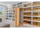 Bright living room featuring a custom built-in bookcase with a secret door, and a variety of storage options at 1809 Bowling Rd, Fuquay Varina, NC 27526
