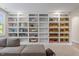 Bright living room featuring a custom built-in bookcase with a variety of storage options and natural light at 1809 Bowling Rd, Fuquay Varina, NC 27526