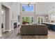 Bright living room with hardwood floors, a fireplace, and a large window providing lots of natural light at 1809 Bowling Rd, Fuquay Varina, NC 27526