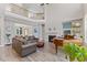 Open living room featuring a fireplace, piano, hardwood floors, and a railing overlooking the lower level at 1809 Bowling Rd, Fuquay Varina, NC 27526