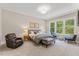 Spacious main bedroom with large windows, sitting area, and neutral tones at 1809 Bowling Rd, Fuquay Varina, NC 27526