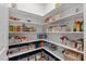 Walk-in pantry with organized shelving stocked with various food items and storage containers at 1809 Bowling Rd, Fuquay Varina, NC 27526