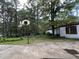 An outdoor basketball hoop beside a backyard and a building with red trim at 194 John Mitchell Rd, Youngsville, NC 27596