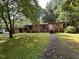 A single story brick home with a chimney and a sidewalk leading to the front door at 194 John Mitchell Rd, Youngsville, NC 27596