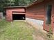 Open garage showcasing a lawnmower and miscellaneous items at 194 John Mitchell Rd, Youngsville, NC 27596