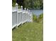 A white picket fence borders a grassy lawn leading to the lake view beyond at 2011 Bowmantown Rd, Roxboro, NC 27574