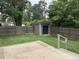 This backyard features a full fence for privacy, storage shed, and grass area at 205 Woodhaven Dr, Burlington, NC 27217