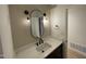 Modern bathroom features a black faucet, sleek fixtures, and a large decorative mirror over a marble countertop at 205 Woodhaven Dr, Burlington, NC 27217