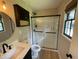 Bathroom featuring sleek glass shower door, and a modern vanity sink at 205 Woodhaven Dr, Burlington, NC 27217