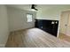 A bedroom featuring modern lighting fixtures, stylish wall paneling, and beautiful hardwood floors at 205 Woodhaven Dr, Burlington, NC 27217