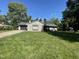 Single-story home featuring a well-manicured front lawn, attached garage, and inviting curb appeal at 205 Woodhaven Dr, Burlington, NC 27217
