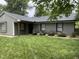 Charming single-story home featuring a well-manicured lawn, covered porch and neutral-toned exterior at 205 Woodhaven Dr, Burlington, NC 27217