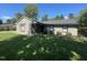 Single story home showing the fresh landscaping, neutral color scheme, and well kept yard at 205 Woodhaven Dr, Burlington, NC 27217