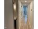 Hallway with light hardwood floors leading to bathroom and bedrooms at 205 Woodhaven Dr, Burlington, NC 27217