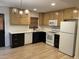 Bright kitchen featuring new white appliances, a white countertop, and two-tone cabinets at 205 Woodhaven Dr, Burlington, NC 27217