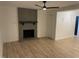 Spacious living room featuring a decorative fireplace, modern ceiling fan and light hardwood floors at 205 Woodhaven Dr, Burlington, NC 27217