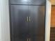 Large pantry with dark-colored cabinet doors and gold hardware at 205 Woodhaven Dr, Burlington, NC 27217