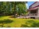 Picture of the backyard showing a well-maintained lawn, deck, outbuilding and inviting outdoor seating area at 206 Lisa Dr, Carrboro, NC 27510