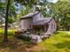 The home's backyard has a spacious deck, hot tub, string lights and well-maintained lawn at 206 Lisa Dr, Carrboro, NC 27510