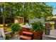 Inviting backyard with a hot tub, outbuilding with art, and manicured landscaping, offers relaxation and entertainment at 206 Lisa Dr, Carrboro, NC 27510