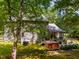 The home features a back deck, a hot tub, lush lawn, and exterior AC units at 206 Lisa Dr, Carrboro, NC 27510