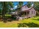 Charming backyard with a well-maintained lawn, a deck featuring inviting outdoor seating, and lush greenery at 206 Lisa Dr, Carrboro, NC 27510